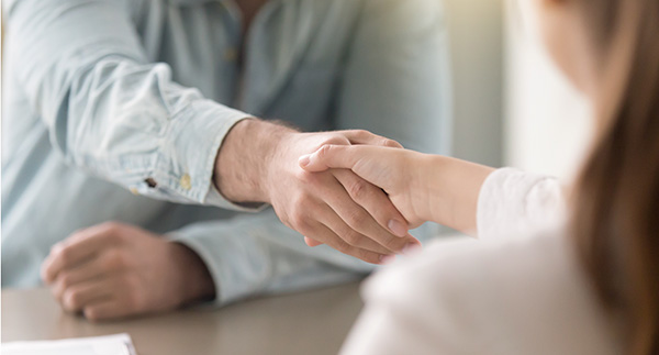 Business agreement handshake of man and woman at the office