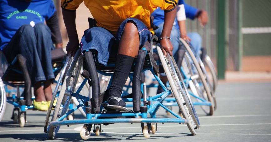Jugadores en silla de ruedas compiten en una actividad de baloncesto adaptado durante una jornada inclusiva de deporte.