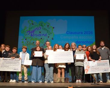 Escolares y representantes institucionales en el escenario del Teatro Circo durante la clausura de la campaña de sensibilización escolar de FAMDIF/COCEMFE-Murcia.