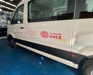COCEMFE Castelló amplía su servicio de transporte adaptado con Fundación ONCE Furgoneta blanca de transporte adaptado de COCEMFE Castelló, con los logotipos de Fundación ONCE y Generalitat Valenciana, estacionada en una nave.