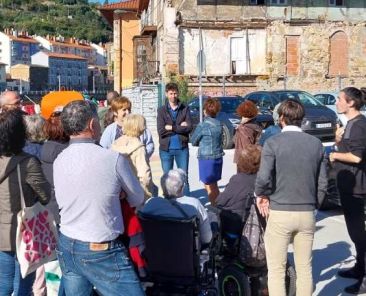 Fekoor organiza rutas accesibles por la Ribera de Deusto Grupo de personas, algunas en sillas de ruedas, reunidas en una calle de la Ribera de Deusto junto a un antiguo edificio.